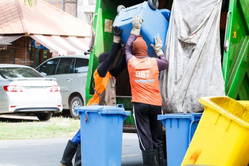 Early morning man and van team clearing waste from a busy town centre property